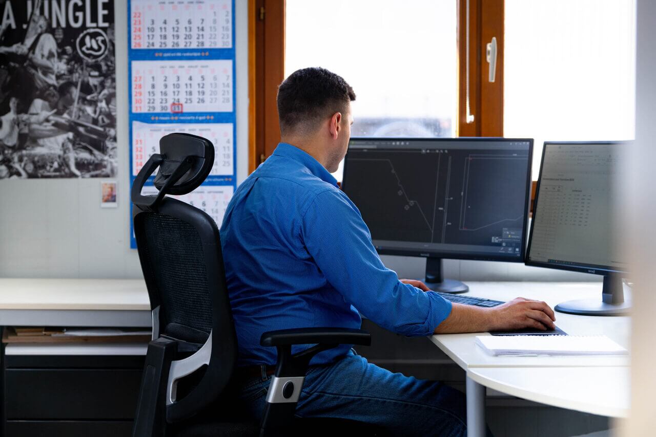 Mr Launois working in front of his PC